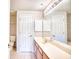 Bathroom with light counters, wood cabinets, and a large mirror at 1550 Spinnaker Dr. # 3123, North Myrtle Beach, SC 29582