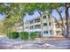 Multi-story condo with private balconies surrounded by mature trees and manicured landscaping at 1550 Spinnaker Dr. # 3123, North Myrtle Beach, SC 29582