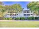 Well-maintained condo building surrounded by lush landscaping and mature trees at 1550 Spinnaker Dr. # 3123, North Myrtle Beach, SC 29582