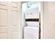 A laundry closet with a stackable washer and dryer behind a closed door at 1550 Spinnaker Dr. # 3123, North Myrtle Beach, SC 29582