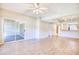 Open living room with wood floors, sliding glass doors to the patio, and a view to the kitchen at 1550 Spinnaker Dr. # 3123, North Myrtle Beach, SC 29582