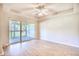 Living room with wood floors and sliding glass doors to the outdoor patio with a view at 1550 Spinnaker Dr. # 3123, North Myrtle Beach, SC 29582