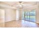 Bright living room with wood floors, ceiling fan, and sliding glass doors to a patio at 1550 Spinnaker Dr. # 3123, North Myrtle Beach, SC 29582