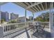 Balcony with metal table and chairs overlooking the city and neighborhood at 1613 Havens Dr., North Myrtle Beach, SC 29582