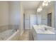 Large bathroom with a soaking tub, double vanity with white cabinets, tile flooring, and glass-enclosed shower at 1613 Havens Dr., North Myrtle Beach, SC 29582