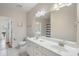 Bright bathroom boasts double sinks, a large mirror, and neutral wall color at 1613 Havens Dr., North Myrtle Beach, SC 29582