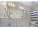 Bright bathroom with double sink vanity, white cabinets, large mirror, nautical decor, and a shower/tub combo at 1613 Havens Dr., North Myrtle Beach, SC 29582