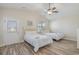 Bright bedroom with vaulted ceiling features two beds, wood-look floors, and natural light from a window and door at 1613 Havens Dr., North Myrtle Beach, SC 29582