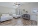 Bright bedroom with vaulted ceiling features two beds, a crib, wood-look floors, and natural light from a window at 1613 Havens Dr., North Myrtle Beach, SC 29582