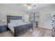 Cozy bedroom features a black bed, ceiling fan, and access to an exterior door at 1613 Havens Dr., North Myrtle Beach, SC 29582