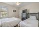 A cozy bedroom featuring twin beds, dark wood dresser, and natural light at 1613 Havens Dr., North Myrtle Beach, SC 29582