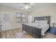 Well-lit bedroom features a large bed with white linens, a ceiling fan, wood-look flooring, and natural light from the window at 1613 Havens Dr., North Myrtle Beach, SC 29582