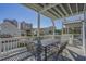 Covered deck featuring a dining table, chairs, and views of the city skyline on a bright, sunny day at 1613 Havens Dr., North Myrtle Beach, SC 29582