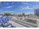 Expansive deck with blue seating offers panoramic views of the surrounding neighborhood and blue skies at 1613 Havens Dr., North Myrtle Beach, SC 29582