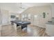 Spacious game room featuring a pool table, air hockey table, high ceilings, and natural light from several windows at 1613 Havens Dr., North Myrtle Beach, SC 29582