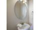 Neat powder room features a pedestal sink with an oval mirror and towel ring at 1613 Havens Dr., North Myrtle Beach, SC 29582