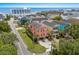 Eye-level aerial view of vibrant coral home and proximity to beach, with a circular drive and lush lawn at 1617 N Dogwood Dr. N, Surfside Beach, SC 29575