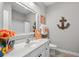 Cozy bathroom with a vanity sink, decorative anchor, and nautical themed decor at 1617 N Dogwood Dr. N, Surfside Beach, SC 29575