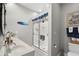 Bathroom with double sink vanity, glass shower door, and coastal-themed decor at 1617 N Dogwood Dr. N, Surfside Beach, SC 29575