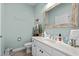 Cozy bathroom with beach-themed décor, white vanity, and decorative mirror at 1617 N Dogwood Dr. N, Surfside Beach, SC 29575