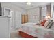 Bright bedroom with coral themed decor, white bedding, and lots of natural light at 1617 N Dogwood Dr. N, Surfside Beach, SC 29575