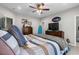 Bedroom with a ceiling fan, wooden dresser, a surfboard and a comfortable bed at 1617 N Dogwood Dr. N, Surfside Beach, SC 29575