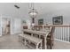 Upstairs dining area with a white table, decorative chandelier, and modern decor at 1617 N Dogwood Dr. N, Surfside Beach, SC 29575