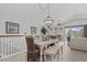 Dining area with a white table and decorative chandelier, offering a bright and inviting space at 1617 N Dogwood Dr. N, Surfside Beach, SC 29575
