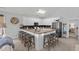 Kitchen with breakfast bar seating, white cabinets, stainless steel appliances, and modern finishes at 1617 N Dogwood Dr. N, Surfside Beach, SC 29575
