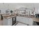 Open kitchen view showcasing modern appliances, white cabinets, and breakfast bar, connecting to the living area at 1617 N Dogwood Dr. N, Surfside Beach, SC 29575