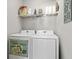 Bright laundry area featuring front-load washer and dryer, with storage shelf above at 1617 N Dogwood Dr. N, Surfside Beach, SC 29575