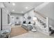 Comfortable living room with neutral tones, staircase, and seamless flow throughout the home at 1617 N Dogwood Dr. N, Surfside Beach, SC 29575