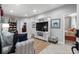 Cozy living room with comfortable seating, TV, and stylish decor that extends into the bedroom at 1617 N Dogwood Dr. N, Surfside Beach, SC 29575