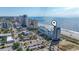 An aerial view of a beach hotel with palm trees, city view, and ocean view at 1708 N Ocean Blvd. # 101, Myrtle Beach, SC 29577