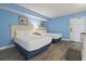 Bright bedroom featuring two beds, light blue walls and laminate flooring at 1708 N Ocean Blvd. # 101, Myrtle Beach, SC 29577