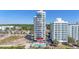 Exterior shot of condo building with Unit 101 identified and pool view at 1708 N Ocean Blvd. # 101, Myrtle Beach, SC 29577