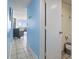 Hallway leading to ocean view living room with blue accent wall and tiled floors at 1708 N Ocean Blvd. # 101, Myrtle Beach, SC 29577
