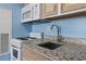 Kitchen featuring granite countertops, appliances, and white cabinetry at 1708 N Ocean Blvd. # 101, Myrtle Beach, SC 29577