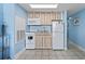 Compact kitchen featuring granite countertops, appliances, and tile flooring at 1708 N Ocean Blvd. # 101, Myrtle Beach, SC 29577