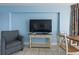 Living area with TV, comfortable armchair, and small dining table and chairs at 1708 N Ocean Blvd. # 101, Myrtle Beach, SC 29577