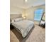 Bedroom featuring a gray bed, large mirror and a window for lots of natural light at 1709 Perthshire Loop, Myrtle Beach, SC 29579