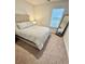 Bedroom featuring a gray bed, large mirror and a window for lots of natural light at 1709 Perthshire Loop, Myrtle Beach, SC 29579