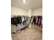 Walk-in closet with ample storage space, featuring clothing racks filled with a variety of garments at 1709 Perthshire Loop, Myrtle Beach, SC 29579