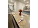 A dining table set for four with a floral centerpiece is adjacent to the kitchen area at 1709 Perthshire Loop, Myrtle Beach, SC 29579