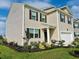 Well-maintained two-story home with a manicured lawn and colorful flower beds enhancing curb appeal at 1709 Perthshire Loop, Myrtle Beach, SC 29579