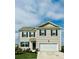Two-story home featuring neutral siding, black shutters, a two-car garage, and a well-manicured lawn at 1709 Perthshire Loop, Myrtle Beach, SC 29579