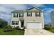 Charming two-story home showcasing manicured landscaping, a two-car garage, and classic curb appeal at 1709 Perthshire Loop, Myrtle Beach, SC 29579