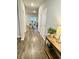 Hallway view to dining area with hardwood floors and natural light, next to a decorative table at 1709 Perthshire Loop, Myrtle Beach, SC 29579