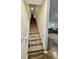 Carpeted staircase with safety gate, leading to the upper level of the home at 1709 Perthshire Loop, Myrtle Beach, SC 29579