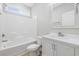 Bathroom featuring shower and tub combo with white cabinets and a large framed mirror with lots of light at 1727 Cane Branch Rd., Loris, SC 29569